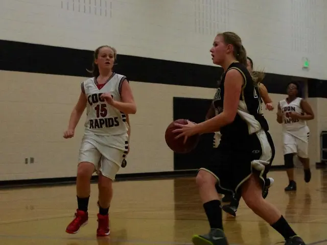 In the image there are a group of people playing basketball in a room and in the background there...