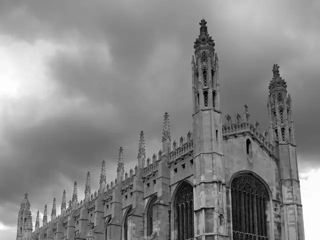 This is a picture where we have some people riding the bicycle and other standing on the road....