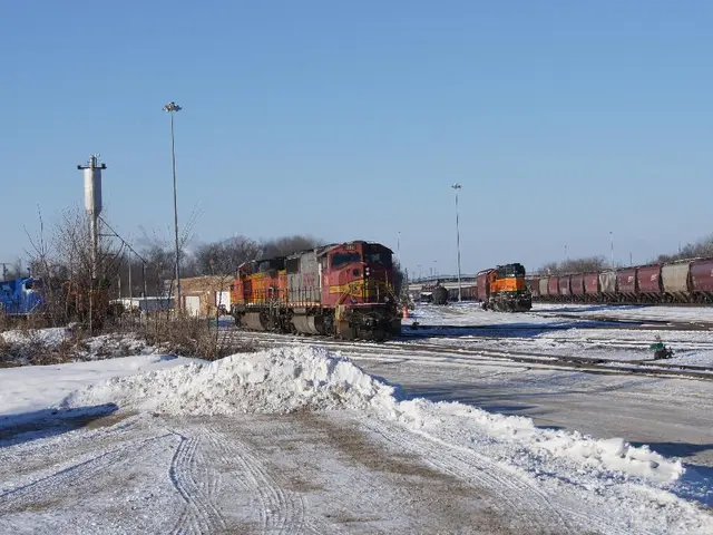 In this picture we can see the train engine in the front. On the right side there is a train bogies...