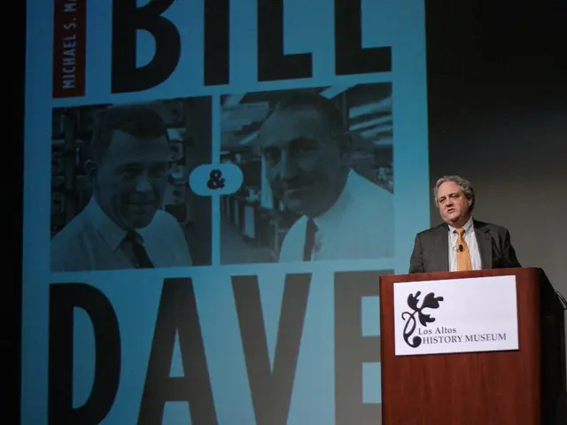 In this image there is a person standing in front of a podium, on that podium there is some text...