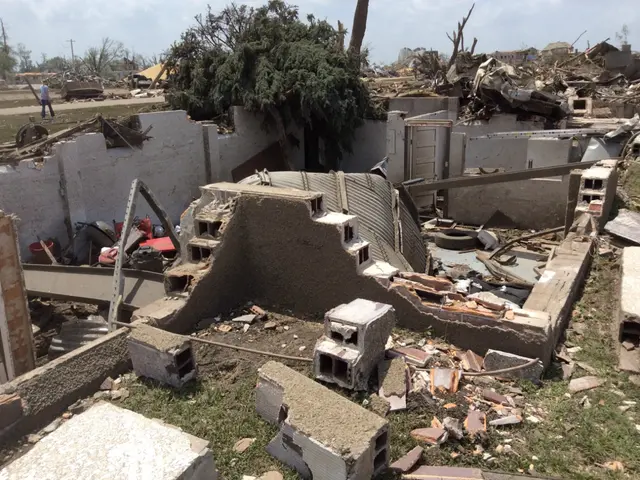 The image shows the aftermath of a tornado in Moore, Oklahoma. We can see the remains of a house...