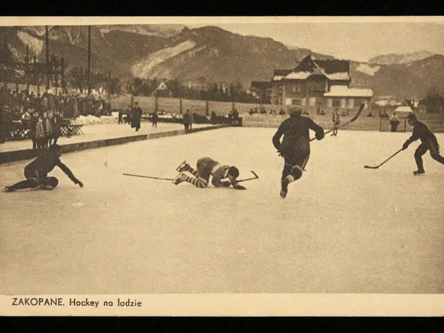 The image shows an old black and white photo of people playing hockey on an ice rink surrounded by...