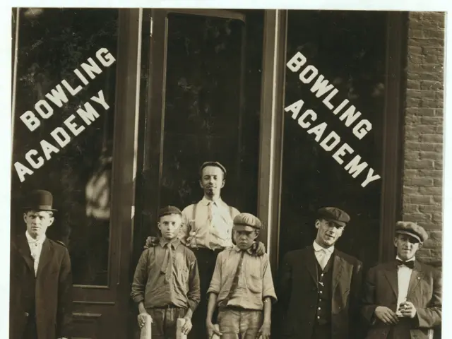 The image shows a group of men standing in front of a bowling academy, with some of them holding...