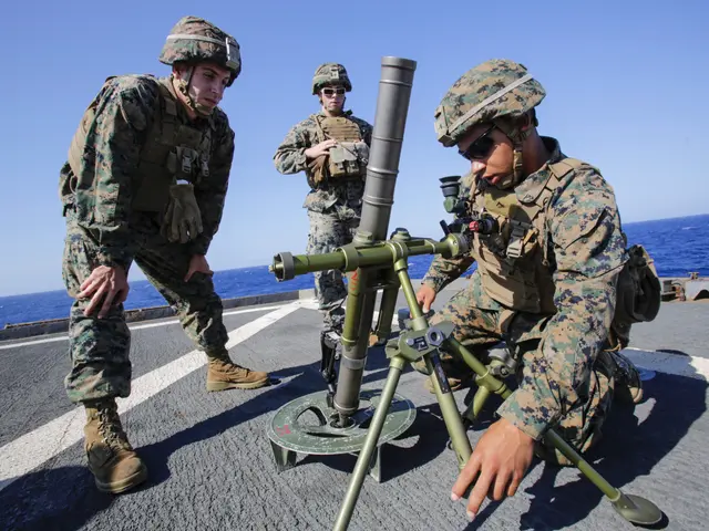 The image shows three marines in camouflage uniforms and helmets standing on the deck of a ship,...