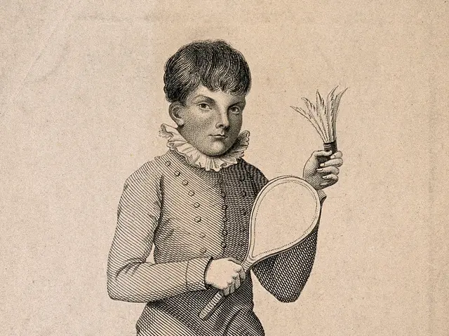 The image shows a young boy standing and holding a tennis racket in his hand. He has a determined...