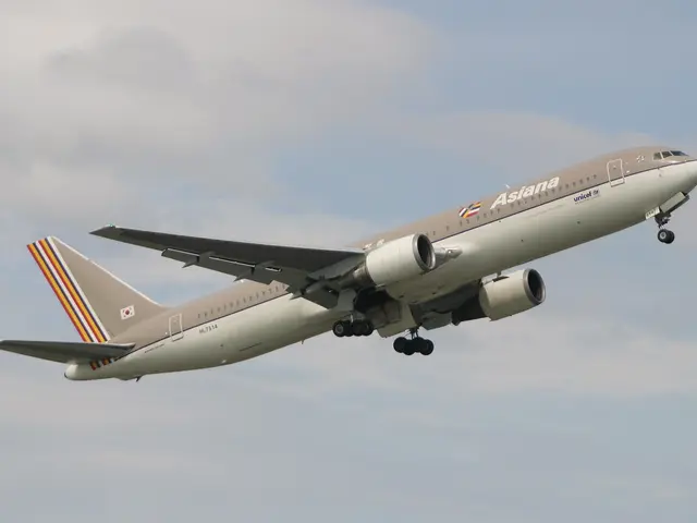 The image shows an Airbus A330-300 of Asia Airlines flying in the sky with white, fluffy clouds in...