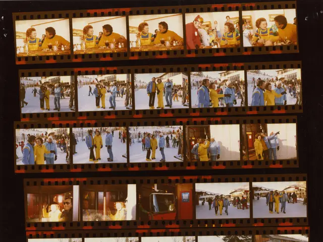The image shows a film strip with a group of people standing in the snow. The people are wearing...