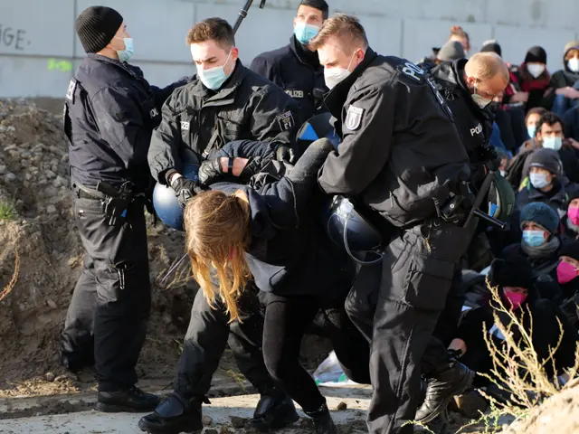 The image shows a group of people wearing masks and caps, some of them holding guns, gathered...