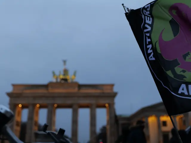 The image shows a group of people standing in front of the Brandenburg Gate in Berlin, Germany,...