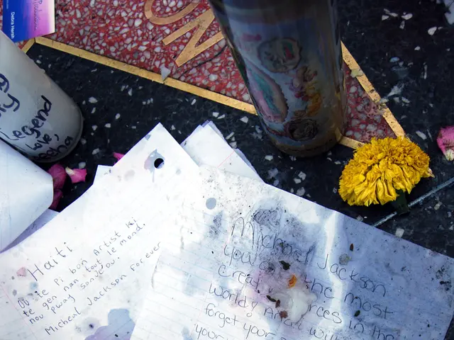 The image shows a memorial on the Hollywood Walk of Fame in Los Angeles, California, with a bouquet...