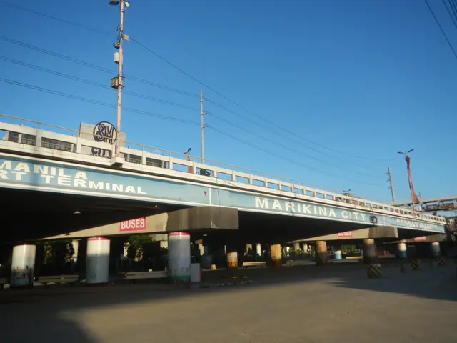 The image shows a bridge with pillars and a name board, electric poles with wires, light poles,...
