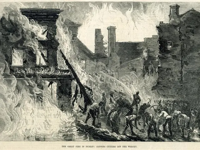 The image shows a group of people standing in front of a burning building, with smoke billowing up...