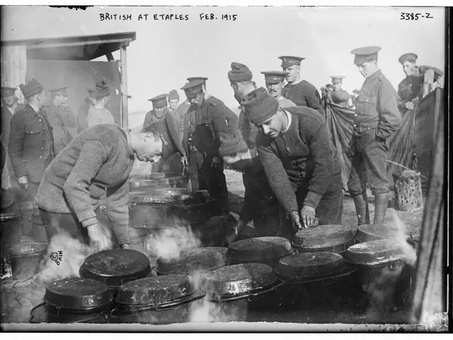 The image shows a group of men wearing caps standing around a table filled with pots and pans, with...