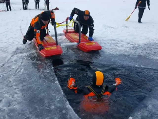 The image shows a group of people standing on top of a snow covered field, with some of them...