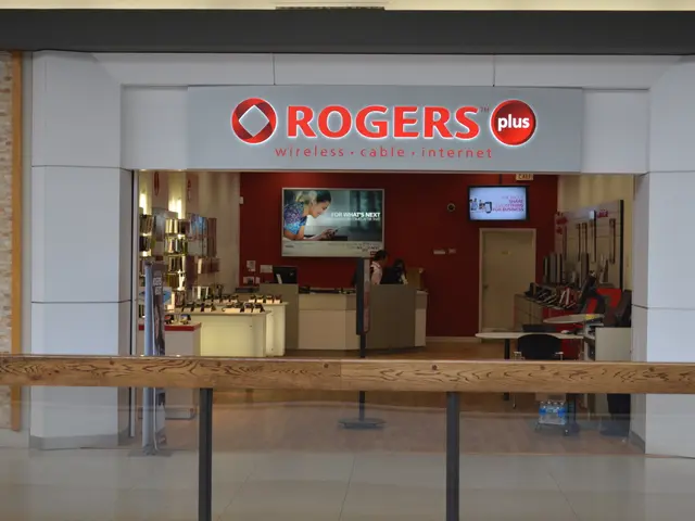 The image shows a Rogers Plus store in a mall with a sign that reads "Rogers Plus" on the wall....