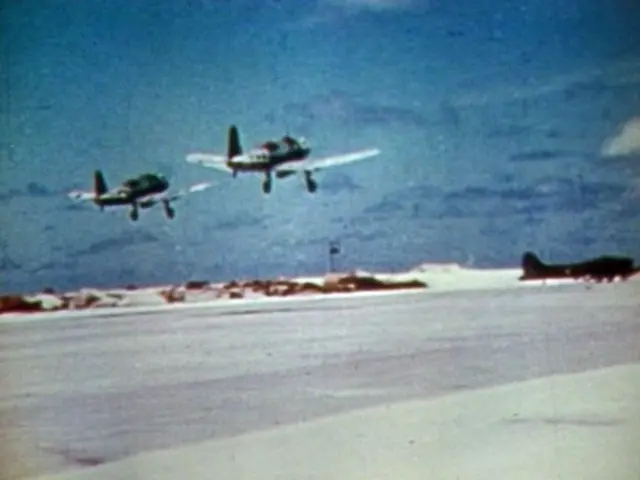 The image shows two airplanes flying in the sky above a snow-covered field. The sky is filled with...