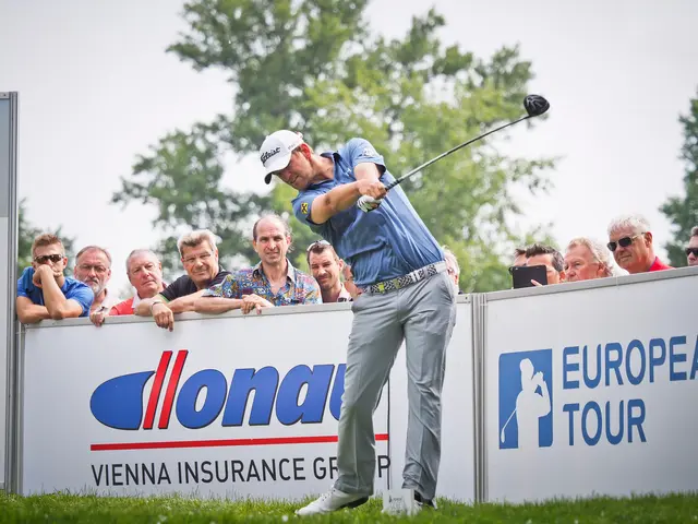 The image shows a man wearing a cap and swinging a golf club on top of a lush green field. In the...