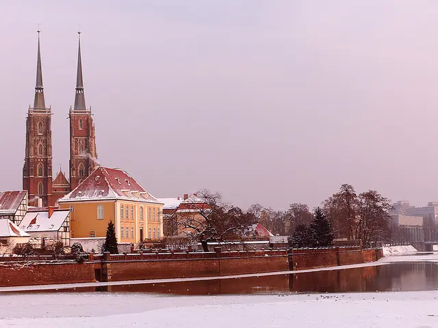 The image shows a picturesque winter scene of Wroclaw, Poland, with snow-covered ground, a body of...