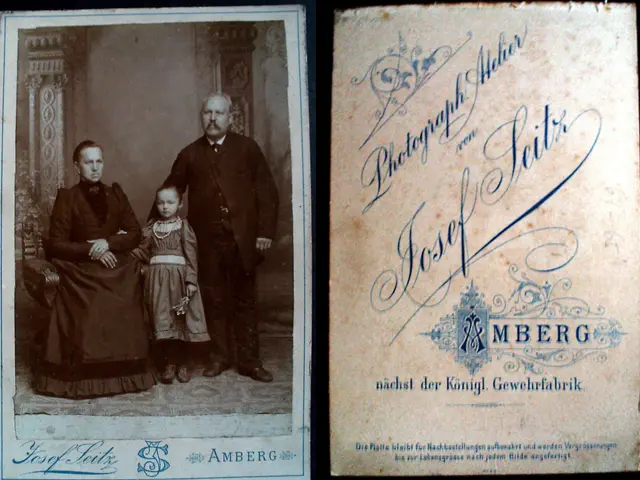 The image shows an old photo of a family posing for a picture. The man and woman are standing side...