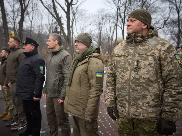 The image shows a group of men in military uniforms standing next to each other on a road...