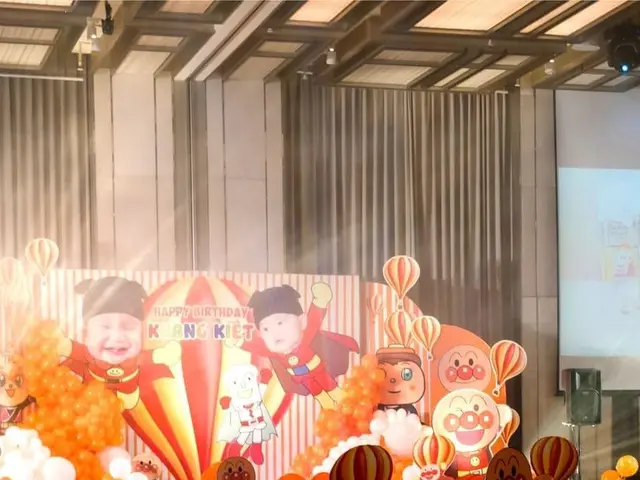 The image shows a room filled with lots of balloons and decorations, including chairs, tables,...