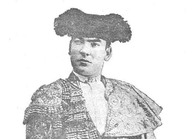 The image shows a black and white photo of Juan Jiménez Ecijano, a matador, standing in the center...