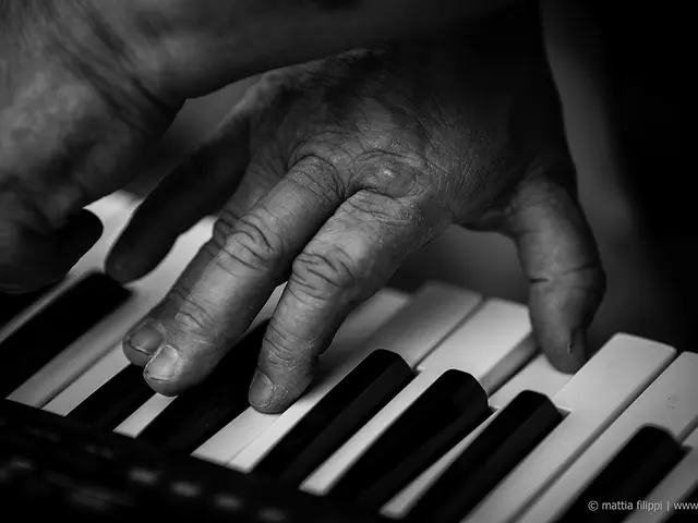 This looks like a man is playing a piano.