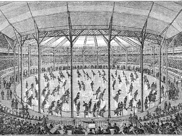 The image shows an old black and white drawing of a large arena with people in it. At the bottom of...