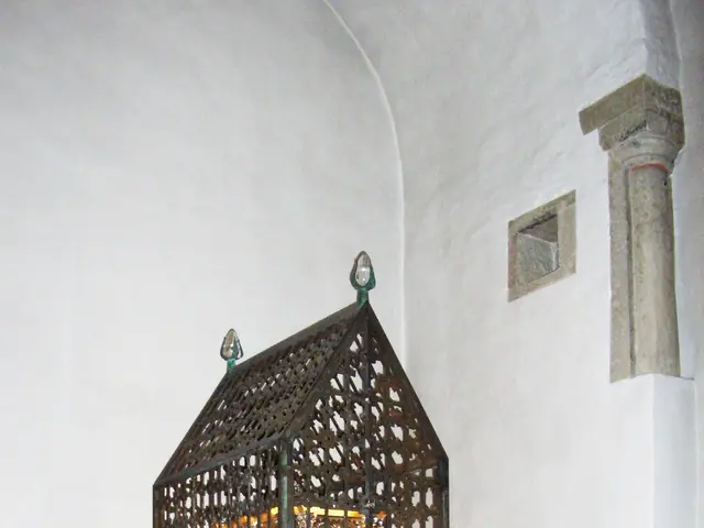 The image shows a small shrine in the middle of a church, with a metal object in the center...