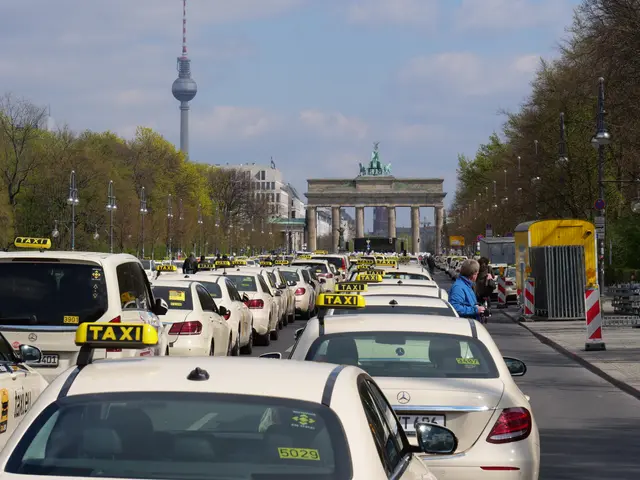 The image shows a bustling street in Berlin, Germany, with a large number of taxis parked on the...