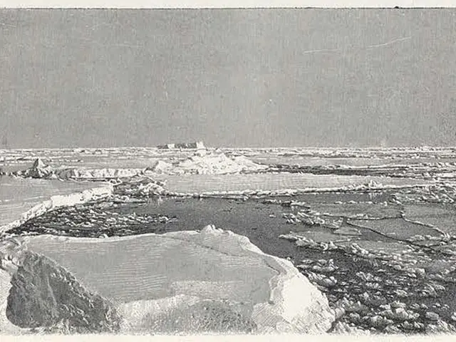 The image shows a black and white photo of a large iceberg in the ocean, with the sky in the...
