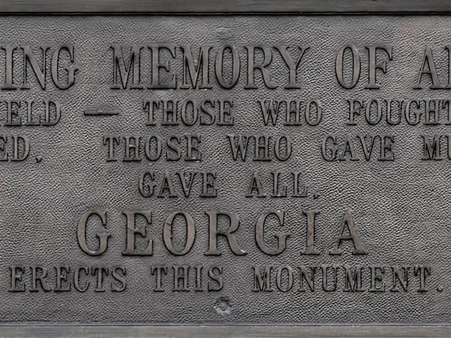 The image shows a plaque on the side of a building that reads "To the Last Memory of All Her Sons"....