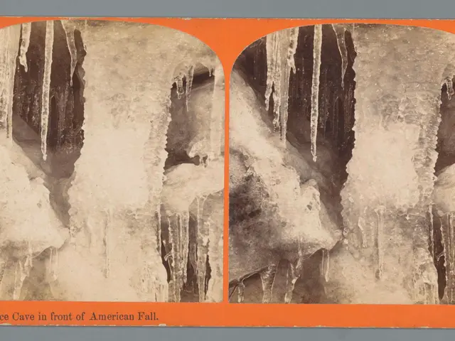 The image shows an old photo of an ice cave in the front of an American fall, with icicles hanging...
