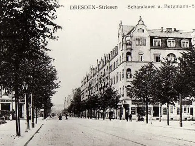 The image shows an old black and white photo of a city street in Dresden, Germany. We can see a...