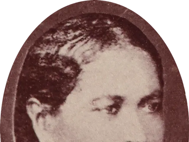 The image shows a black and white photo of a woman wearing earrings. Her face is clearly visible,...