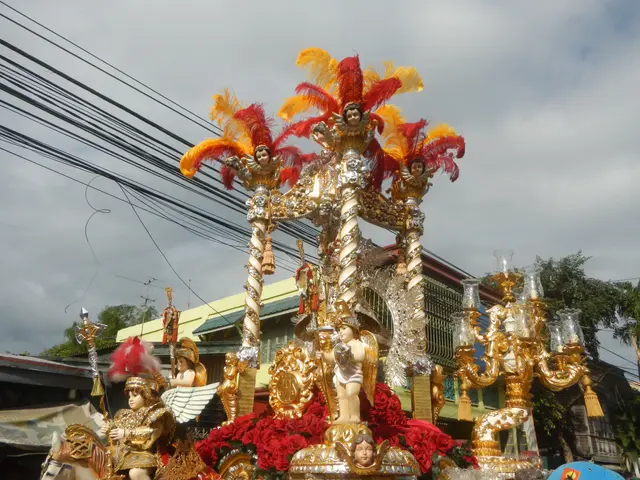 The image shows a float in a carnival parade with people on it, surrounded by buildings, trees,...