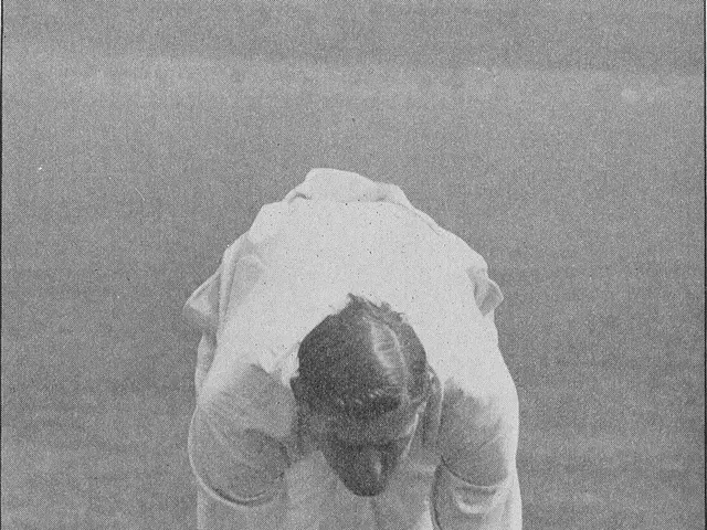 The image shows a man in a white shirt and white pants playing a game of cricket, with a ball on...