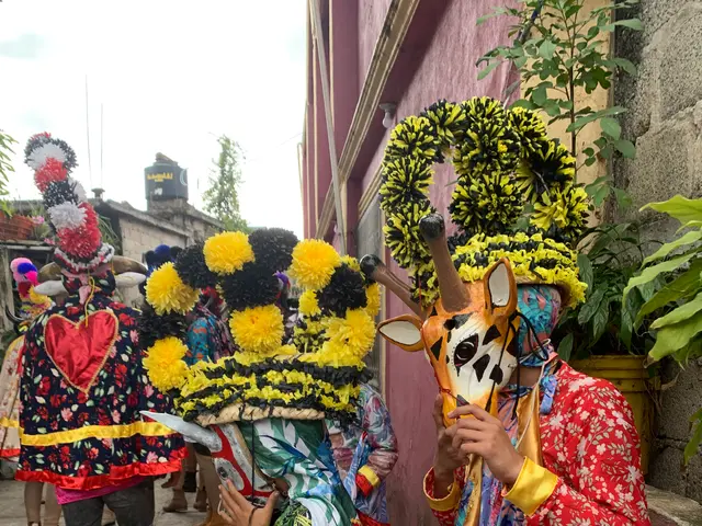 The image shows a group of people standing next to each other in front of a building, wearing...