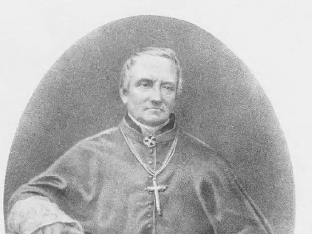 The image shows a black and white photo of a man in a priest's robes, believed to be Pope John Paul...