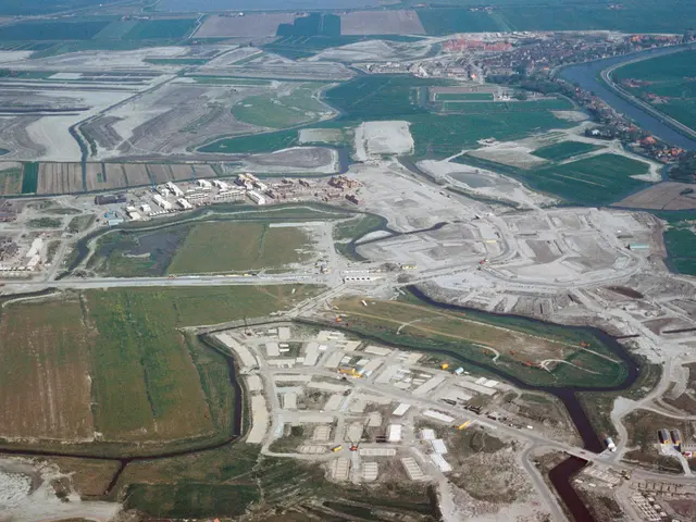 The image shows an aerial view of a large industrial area with a river running through it. We can...
