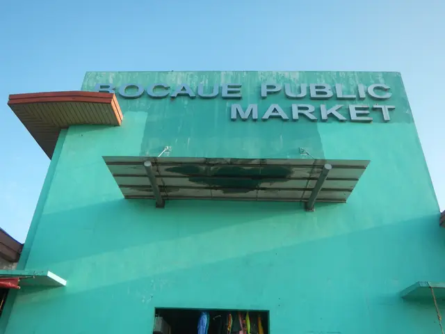 The image shows a green building with a sign that reads "Bocaue Public Market" on it, surrounded by...