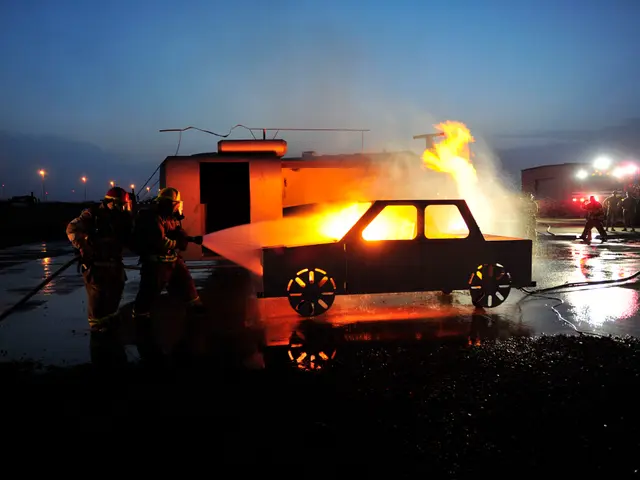 The image shows a group of firefighters wearing helmets and holding pipes, spraying water on a car...