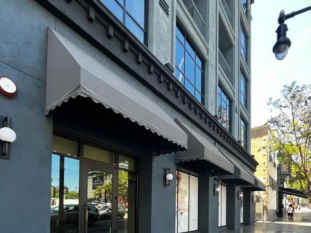 The image shows the Hollywood Walk of Fame in Los Angeles, California. It is a building with glass...