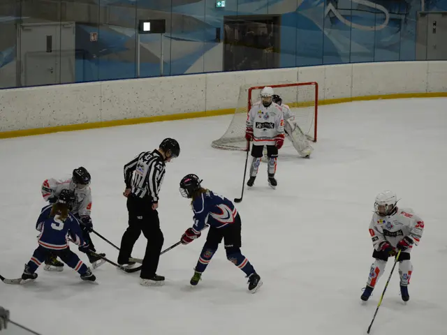 The image shows a group of people playing a game of ice hockey on an ice rink. They are all wearing...