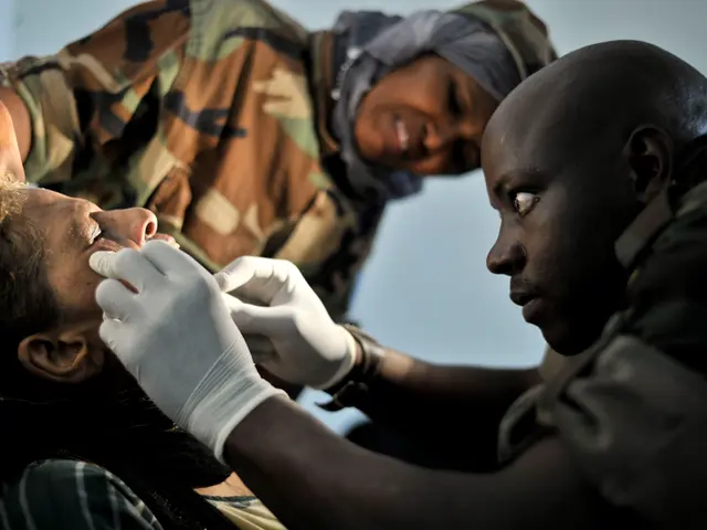 The image shows a man getting a vaccine from a nurse wearing gloves while another person stands...