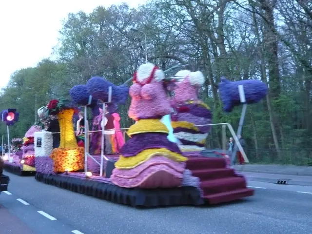 The image shows a float in a parade with people riding bicycles down the street. The float is...