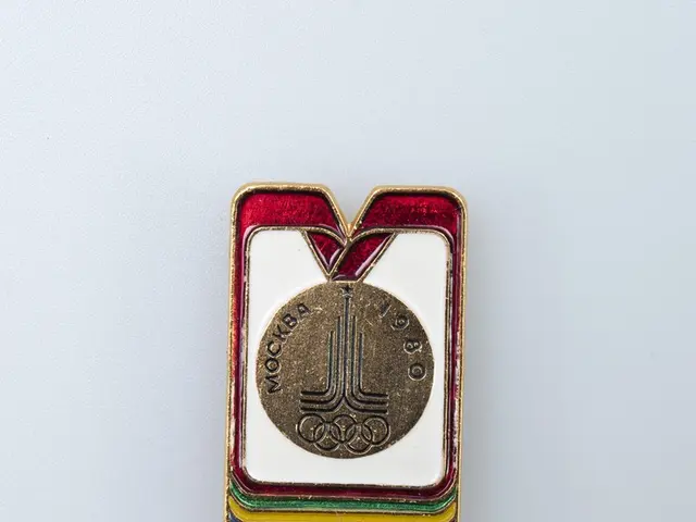 The image shows a white surface with a badge featuring the Olympic medal from the 1980 Winter...