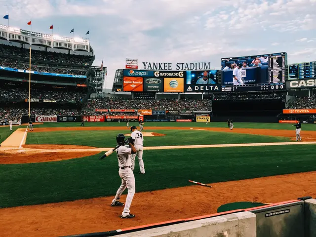 The image shows a baseball game being played in Yankee Stadium, home of the New York Yankees. We...