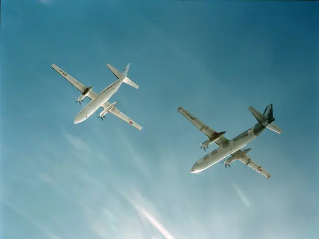 The image shows two airplanes flying side by side in the sky, with a bright blue sky in the...