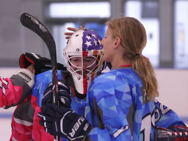 The image shows two women standing next to each other on an ice rink, both wearing sports uniforms...